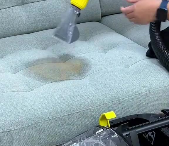 Fabric sofa seat with a large brown stain, before cleaning